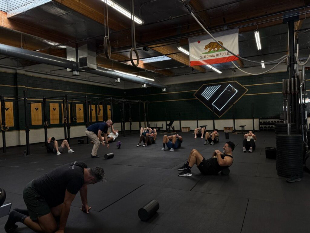 Gym members doing floor mobility work at a Built 2 Move workshop