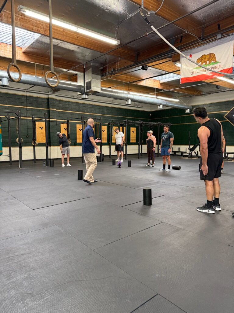 Dr. Armen Rostami coaching gym members through a standing drill